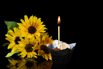 Photo of candles and cupcake on background