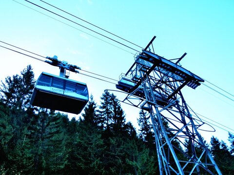 Metal structure of pole, cable car route to Kasprowy Wierch, Kasper Peak in Polish Western Tatras, Tatra Mountains, coniferous forests, blue sky in Tatra National Park in Poland on 20 October 2012