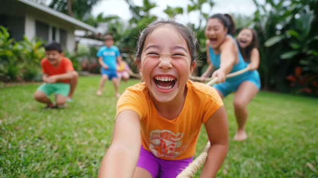 Joyful family playing tug of war outdoors with laughter and fun