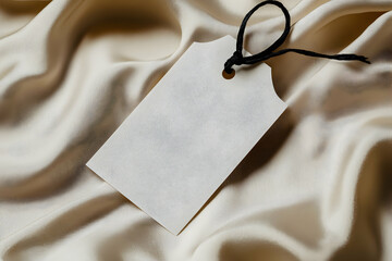Elegant Blank Tag on Beige Silk Fabric:  Perfect for Branding or Mockups