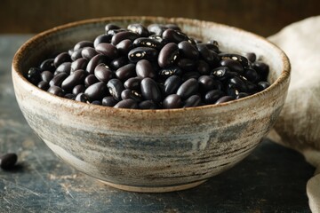 Obraz premium Rich black beans in rustic bowl, highlighting textures and earth