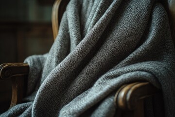 Fototapeta premium Cozy blanket drapes over an armchair, creating warm and inviting