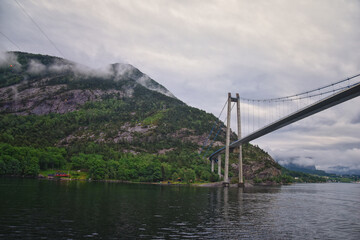 Norway Coast Fjord view from boat on ocean. Mountains, forests, waterfalls and small towns. Scandinavia, Norway