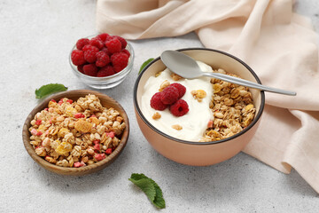 Bowls of tasty granola and berries on grunge background