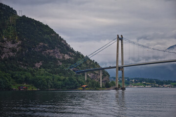 Norway Coast Fjord view from boat on ocean. Mountains, forests, waterfalls and small towns. Scandinavia, Norway