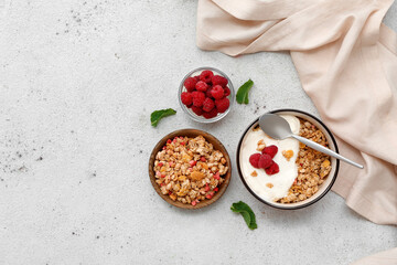 Bowls of tasty granola and berries on grunge background