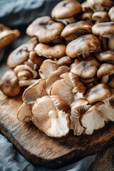 Fototapeta premium Fresh mushrooms displayed on rustic wooden board, showcasing ric