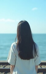 Fototapeta premium an Asian girl looking at the ocean