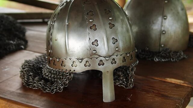 Close-up of a medieval Viking helmet, smooth camera movement, selective focus.

