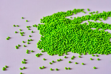 Green masterbatch granules on white background,color pigment carrier polymer in plastic...