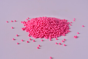 Pink masterbatch granules on white background,color pigment carrier polymer in plastic industry,suitable for plastic company catalog design