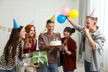18th birthday. Group of friends with tasty cake having coming of age party at home
