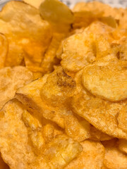 Crispy potato chips piled high on a plate, ready for a tasty snack