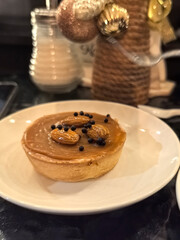 Creamy dessert topped with almonds and chocolate beads