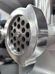 Unique metal meat grinder component with intricate details and design features