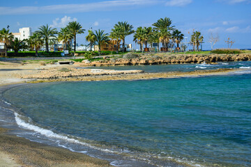 Sandy Beach with Turquoise Water and Palm-Lined Promenade