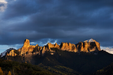USA, Colorado, Uncompahgre National Forest. Sunset on aspens and rock formations.