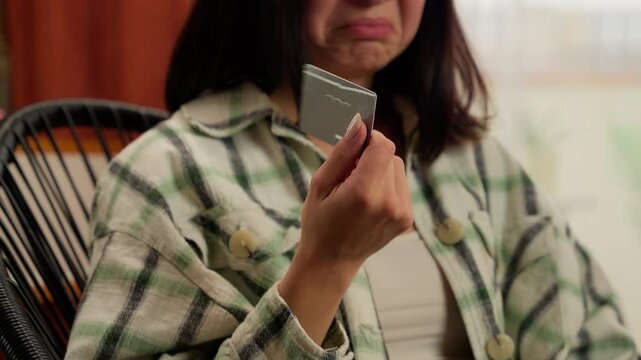 Confused Asian Korean woman credit card bank typing laptop problem error sad female displeased home order wrong password payment online shopping trouble indoors shopper buyer consumer girl mistake pay