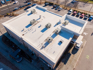 Sunny Day Time Drone Images of a TPO Roof on a Commercial Building.