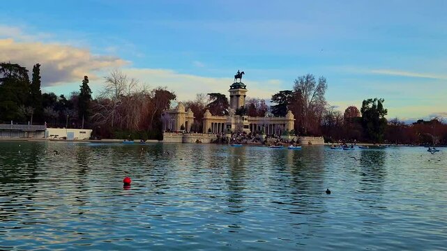 Slow motion birds flying over retiro park lake in madrid