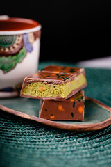 Dubai chocolate with pistachio filling on a black background. Copy space