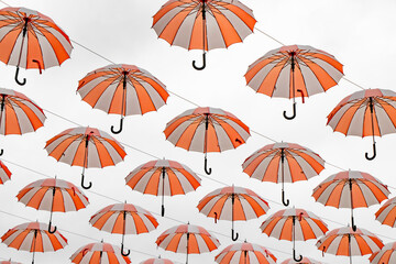 many white, orange striped, floating umbrellas over a center in Beldibi, Kemer in Turkey