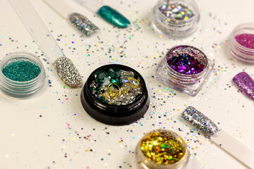 glitter and crystals in boxes for decorating nails and creating a shiny manicure close-up