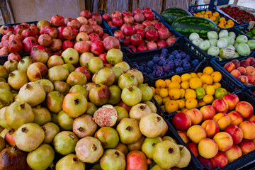 A stand with delicious fruits sorted in boxes with grapefruit, lemons, nectarines, peaches, strawberries, plums, watermelons, on the road in Turkey Beldibi, Kemer, Antalya