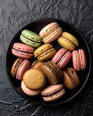 Colorful macarons on black plate