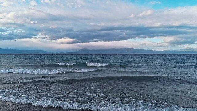 Argentinian Drama. The lake's waves churn under a cloudy, darkening sky, creating a sense of mystery and anticipation. The distant mountains add a touch of grandeur to this evocative scene. 19.01.2025