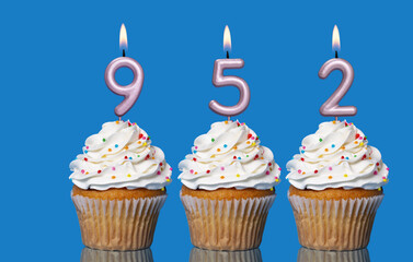 Birthday Cupcakes With Candles Lit Forming The Number 952