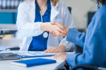 A young African American patient consults with a young Russian medical doctor about her immune system and vitamin intake. They discuss patient medical history,  vitamin and pill bottles on the desk.