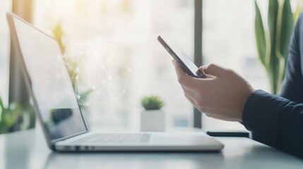 Person using phone and laptop