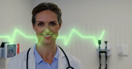 Image of cardiograph over caucasian female doctor smiling in hospital