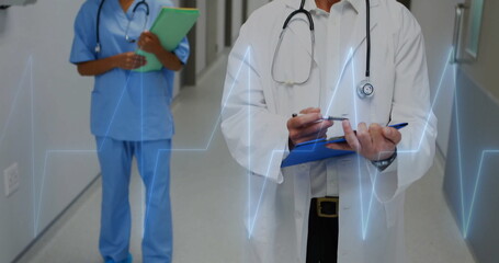 Image of cardiograph over biracial doctors with clipboards