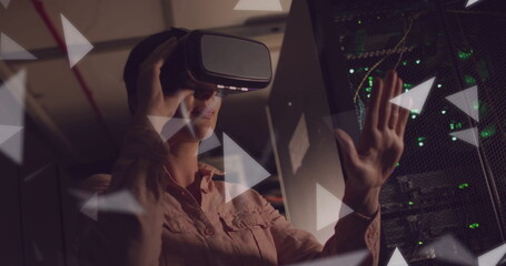 Image of connections over african american woman wearing vr headset by computer servers