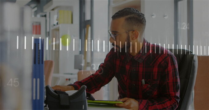Image of data processing and diagrams over biracial man using tablet