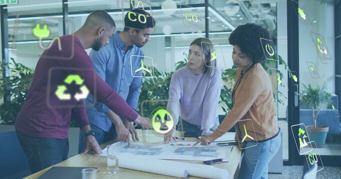 Image of eco icons and data processing over diverse business people in office - Powered by Adobe