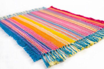 A colorful handcrafted Guatemalan cotton textile laid out to display its bright tones and complex design.

