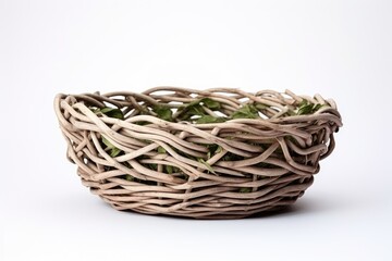 Obraz premium Handmade wicker basket crafted with vines on a white background
