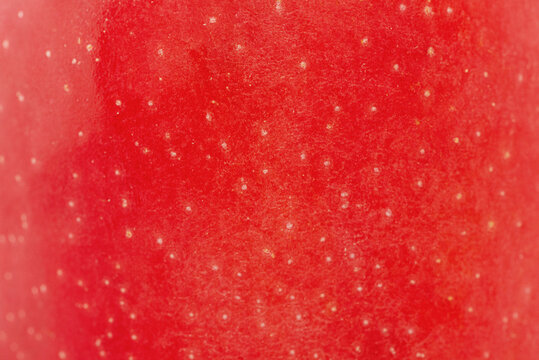 Texture of a red apple as a background macro photo.