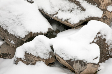 Mountain of snow-covered stones with ice