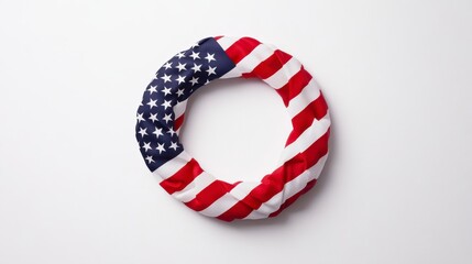 Fototapeta premium Circular lifebuoy wrapped in American flag fabric on white background