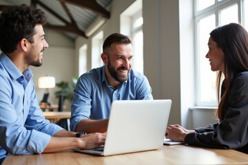 Obraz premium Group of Diverse Business Professionals Collaborating in Bright Modern Office with Laptop on Table, Engaged in Creative and Supportive Dialogue
