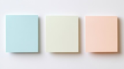 Three different colored sticky notes are lined up on a white background