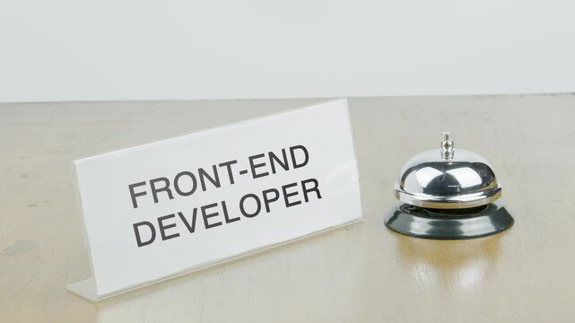 Front-end Developer Office or Room with Hand Ringing The Bell on Desk or Table Multiple Times
