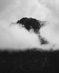 Black and white shot of clouds in the mountains