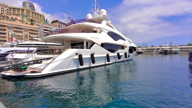 France, French Riviera, Monte Carlo marina with luxury yachts and cars in Monaco bay.