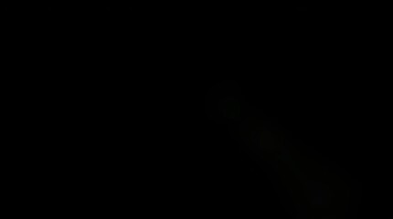 Abstract dark image with soft green light, creating an ethereal mood.