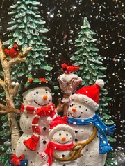 Snowman inside a glove with trees and snow. Kids are hugging the snowman.